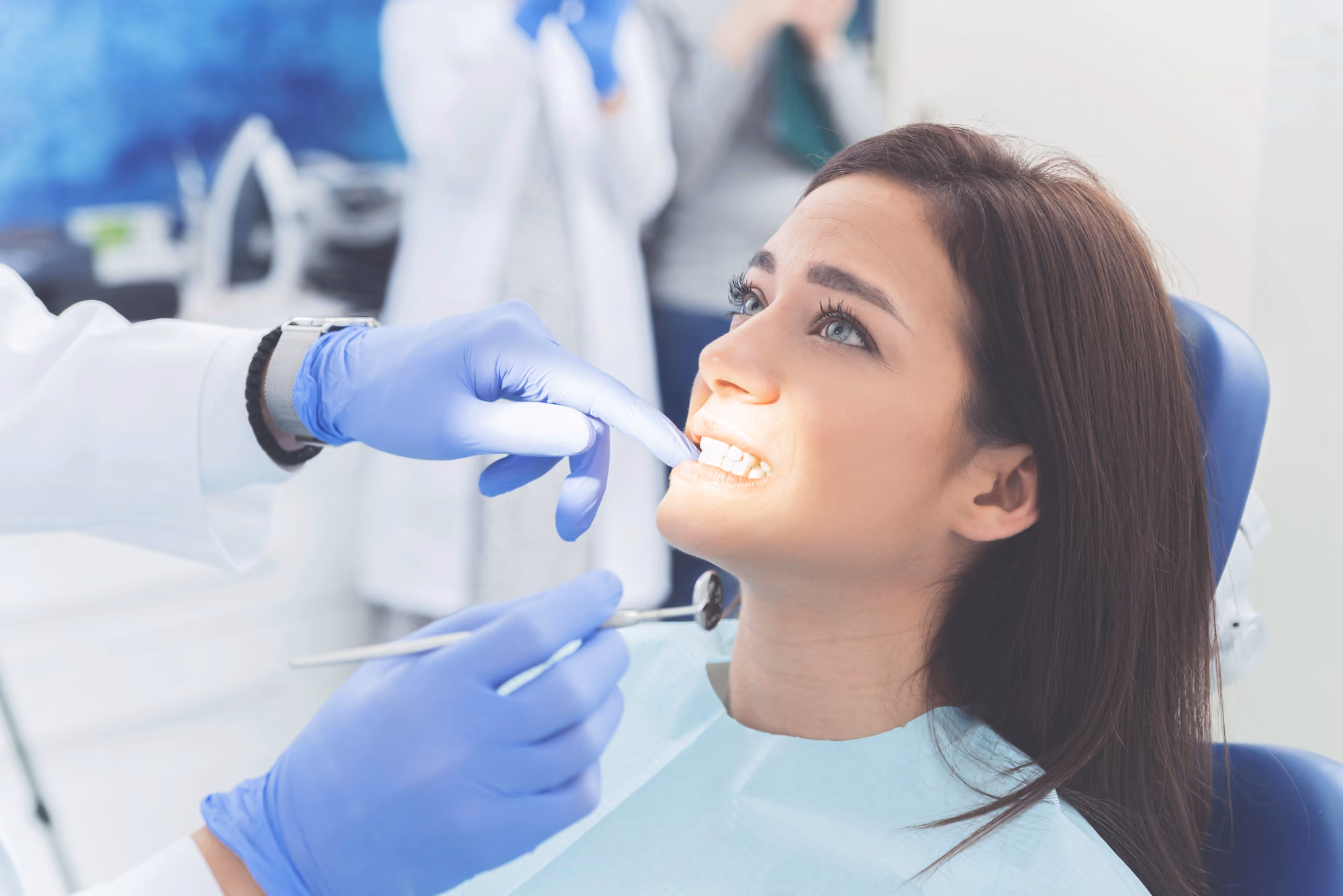 Dentist conducting a comprehensive dental assessment with examination tools.