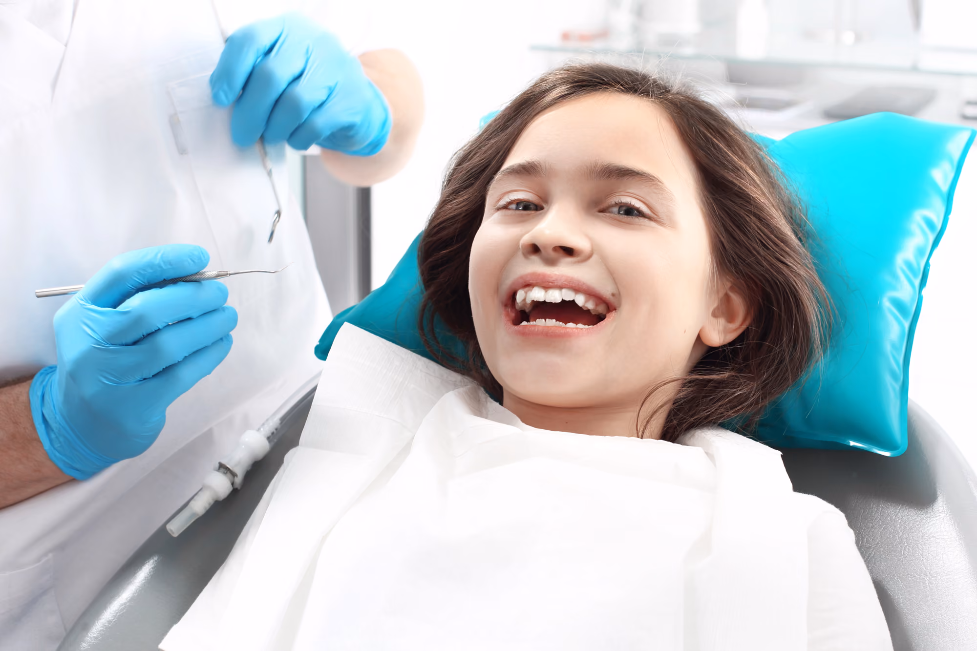Happy child smiling during a routine dental appointment.