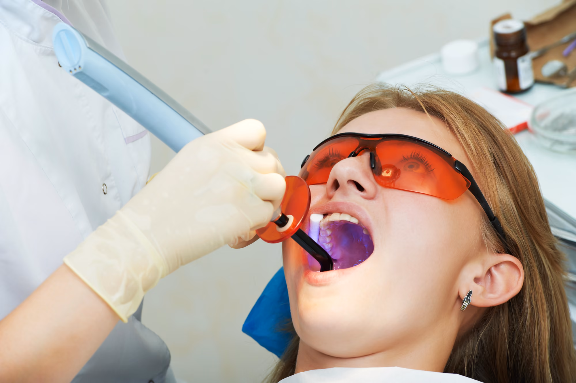 patient wearing protective glasses during a dental restoration procedure.
