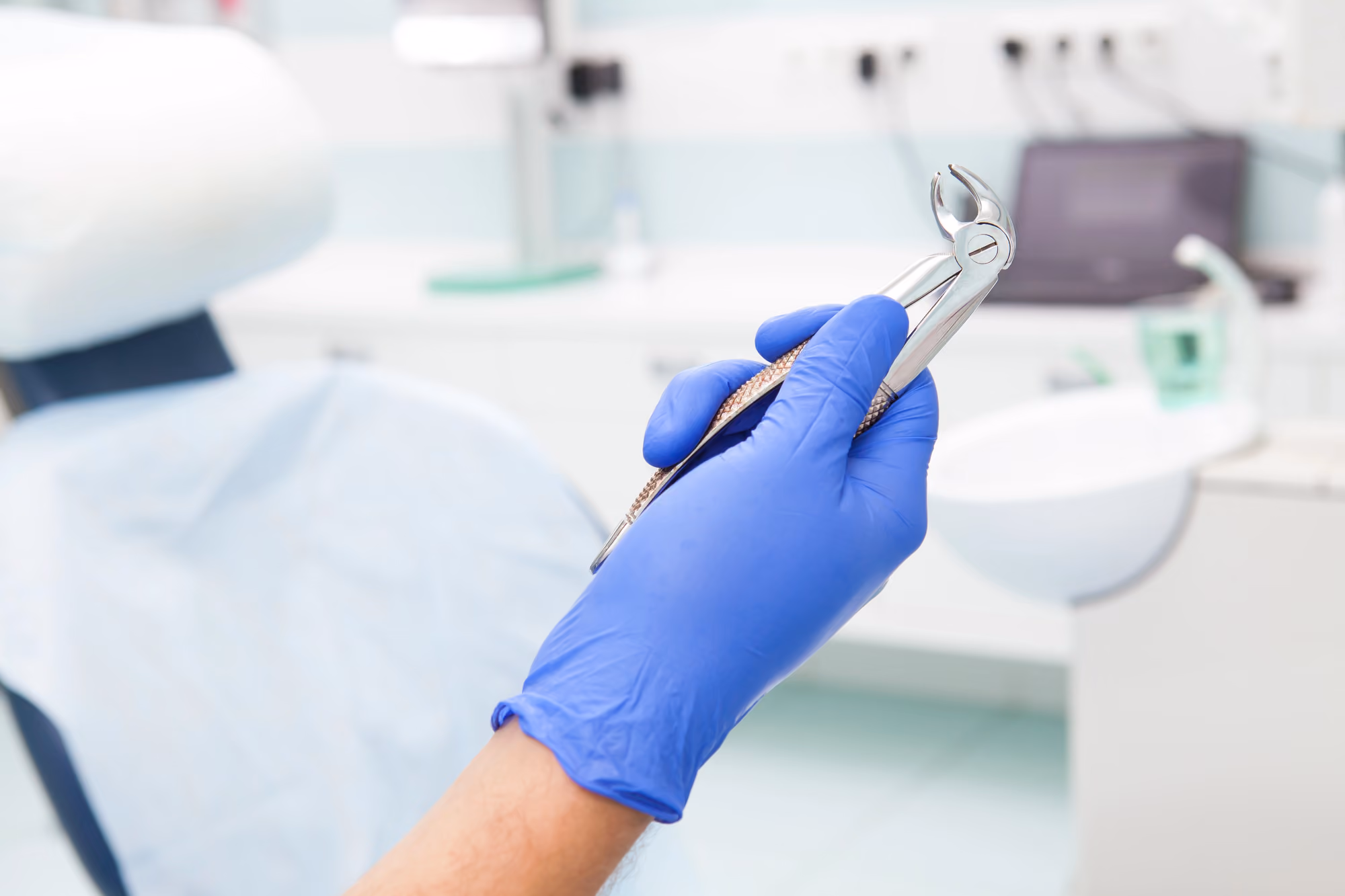 Close-up of dental instruments being used during an oral examination.