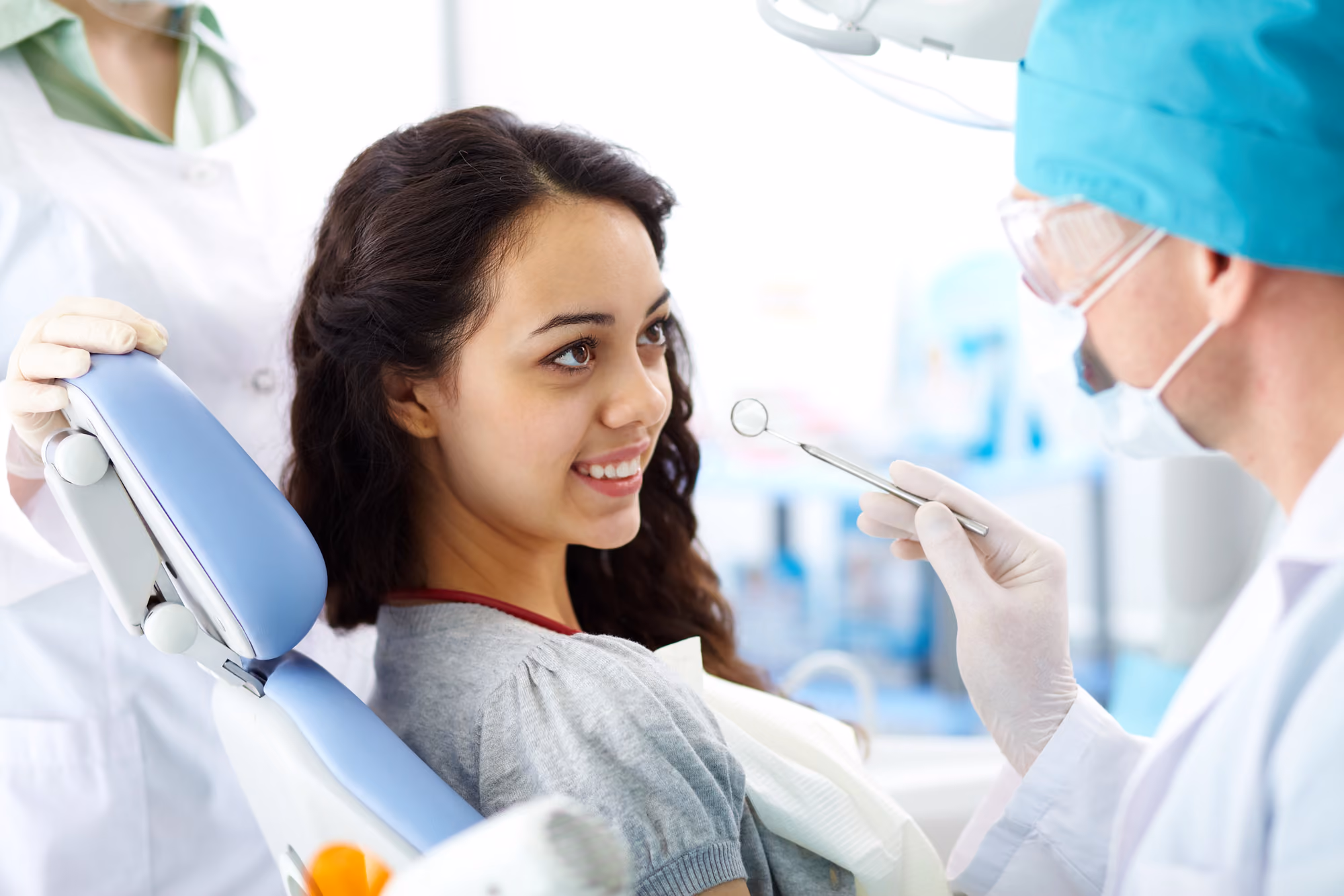 Patient receiving dental care while a dentist works during a procedure.