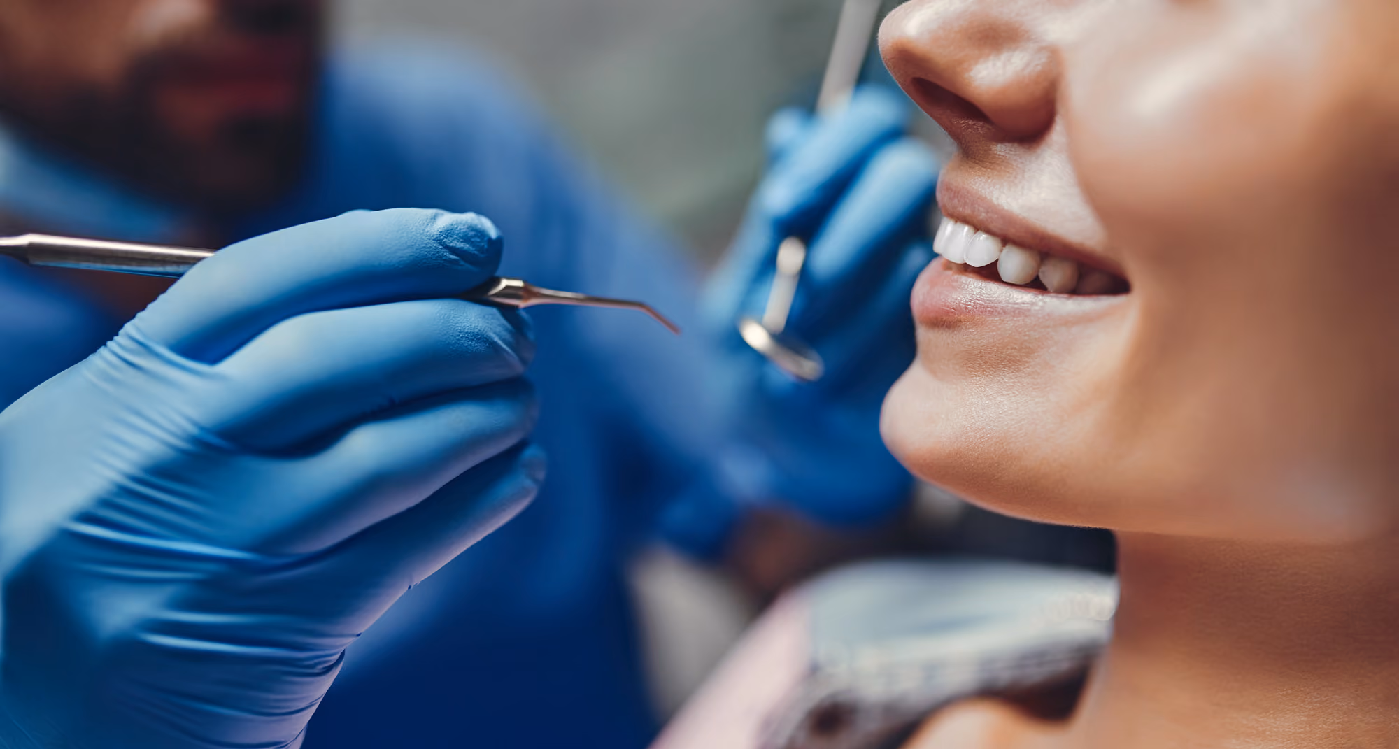 Patient smiling during a cosmetic dental consultation and examination.