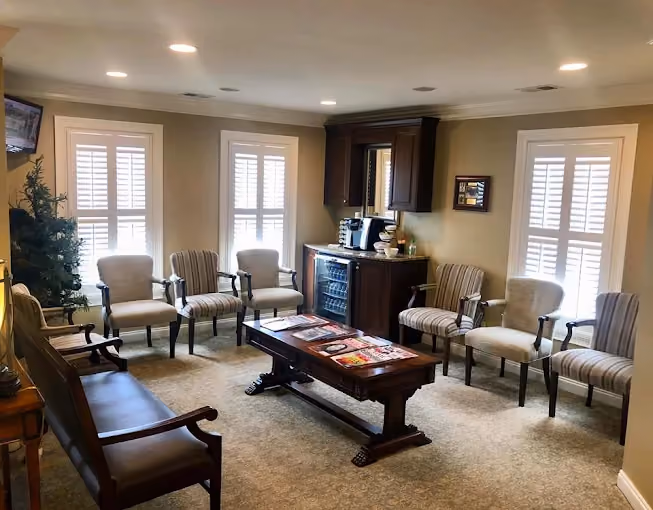 Comfortable dental office waiting room with seating and refreshment area.