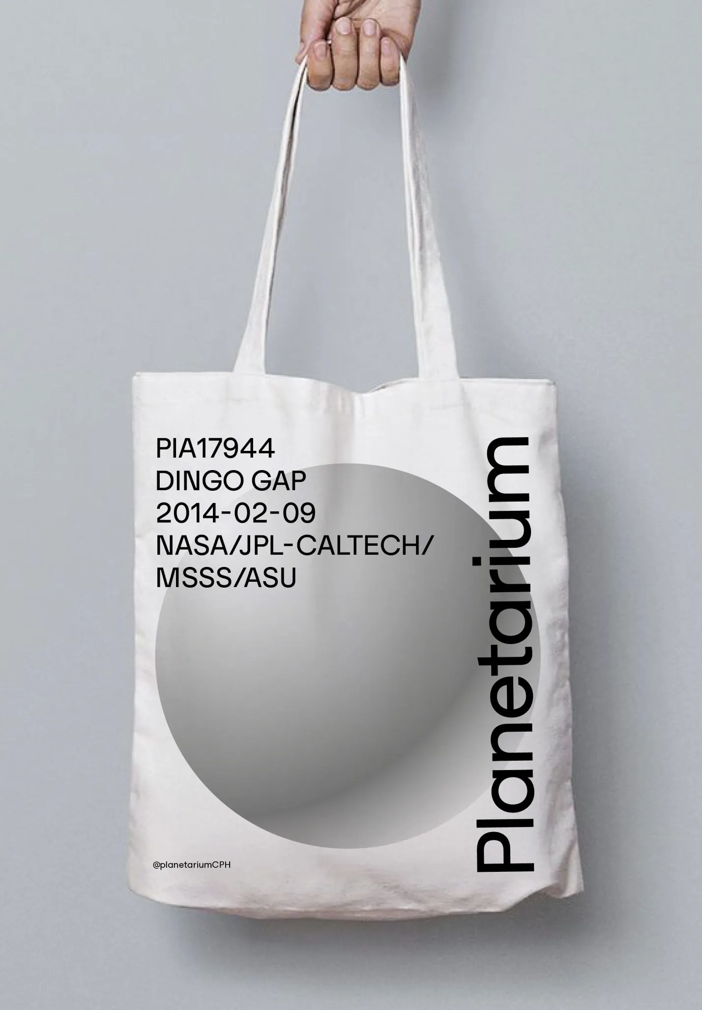 White tote bag with a gray circle image and black text including 'PIA17944 Dingo Gap 2014-02-09 NASA/JPL-Caltech/MSSS/ASU' and 'Planetarium' written vertically.