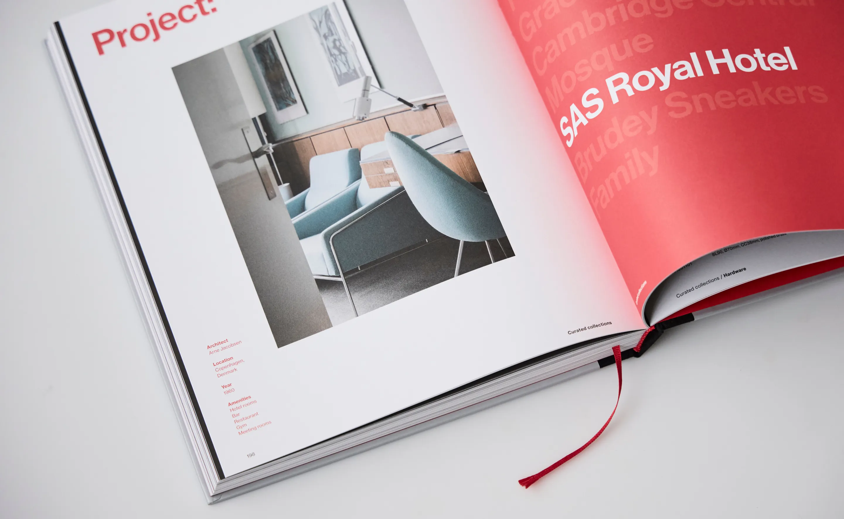 Open book showing a project page with an interior photo of blue chairs and a lamp, mentioning SAS Royal Hotel and architect Arne Jacobsen.