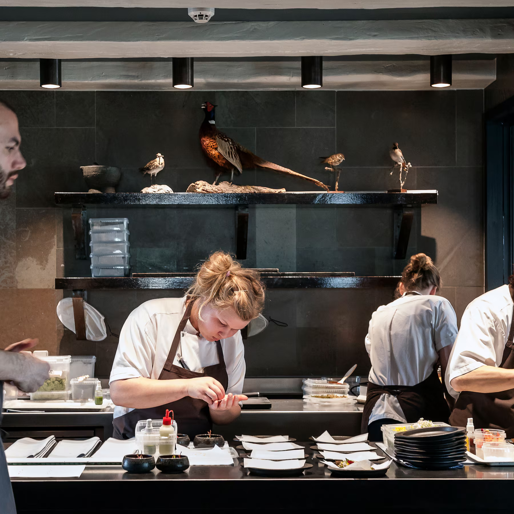 Professional chef focusing on intricate food preparation representing core values