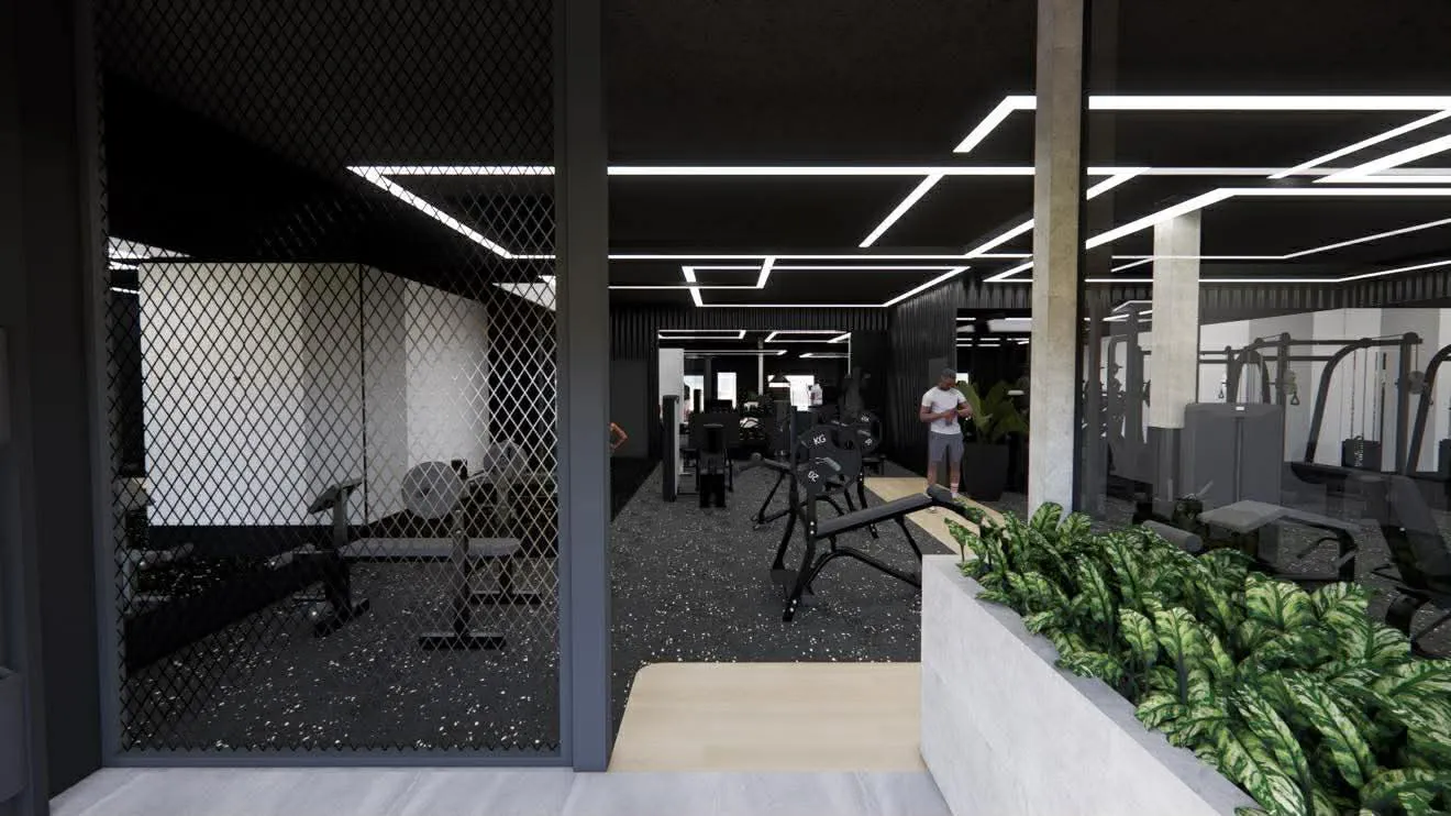 Salle de gym moderne avec appareils de musculation, éclairage LED au plafond et plantes vertes à l'entrée.