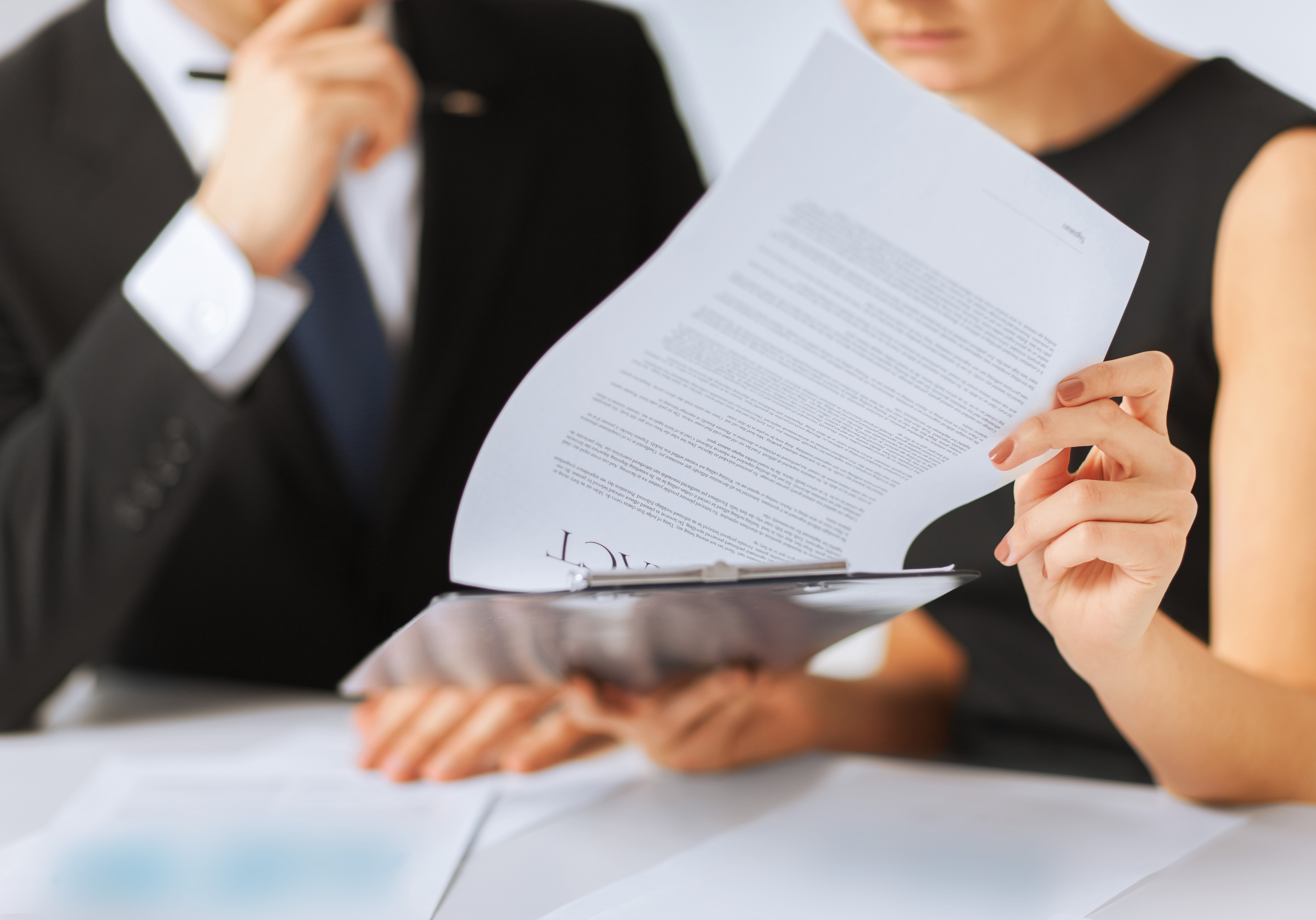 Subscribe to receive NSBA's Regulatory Rundown - man and woman review contract for small business