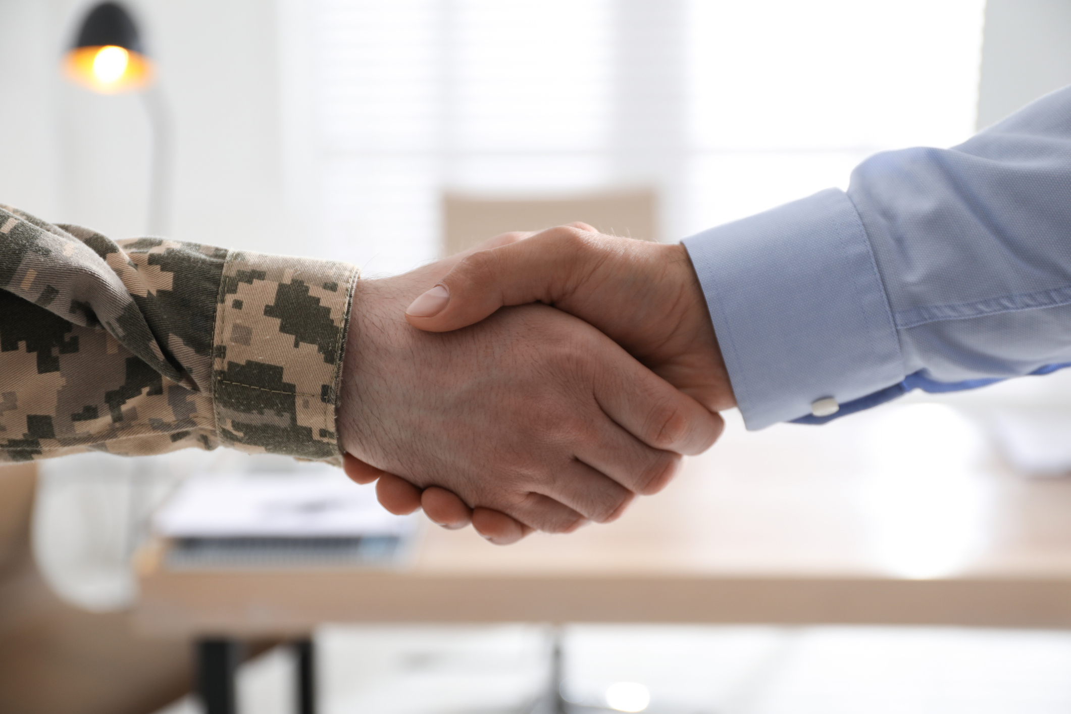 Subscribe to NSBA's Regulatory Rundown - Veteran shaking hand with small-business owner