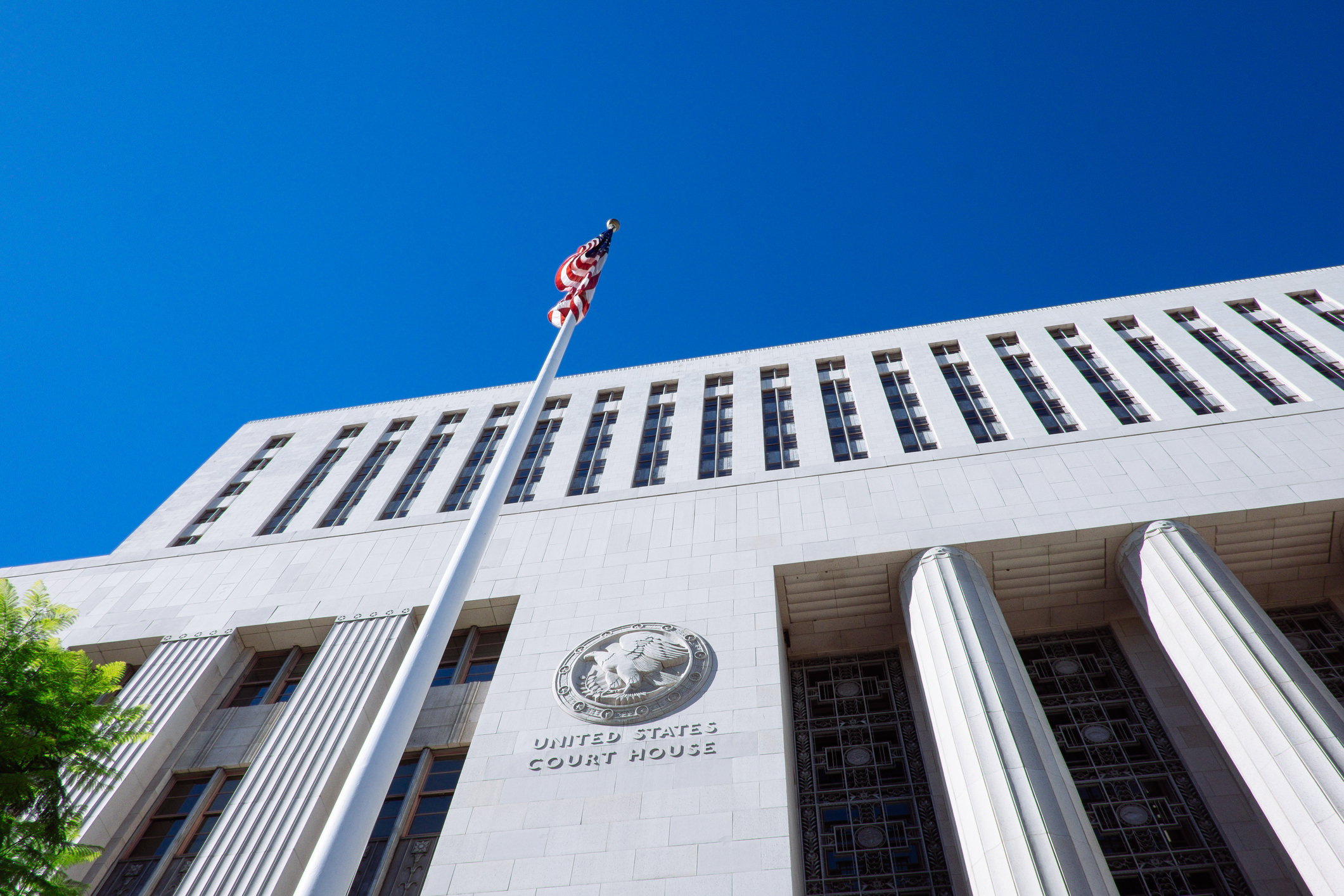 An image of a U.S. Federal Court of appeals, with a blue sky and American flag. 