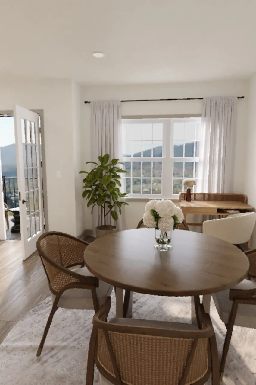 Rendering of a dining area with a round wood table, woven chairs, and a window overlooking the mountains