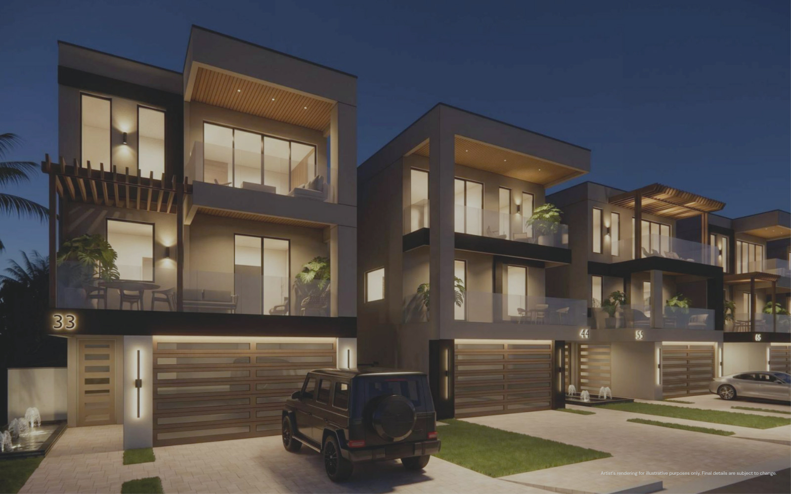 Modern multi-story townhouses at dusk with large glass windows and balconies, illuminated interiors, and cars parked in driveways in front of numbered garages.