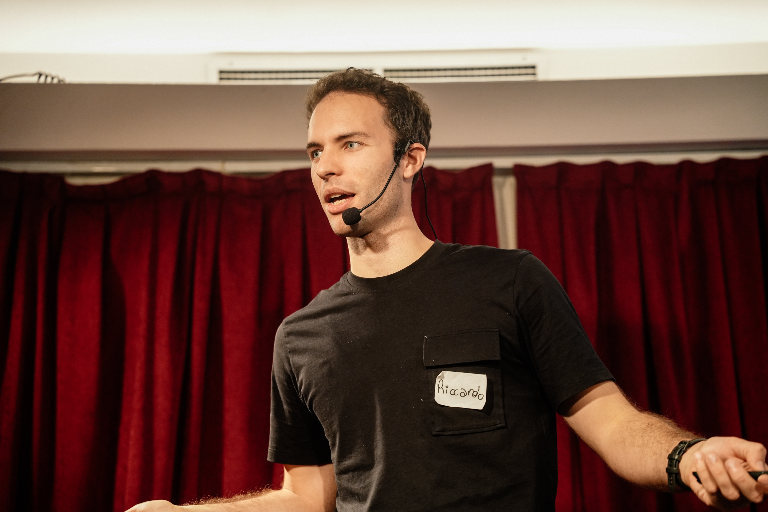 Riccardo Capraro presenting on stage 