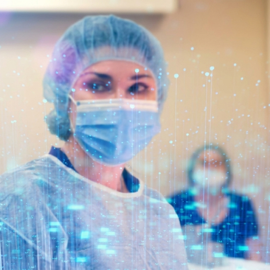 Healthcare professional wearing head covering and mask in operating room.