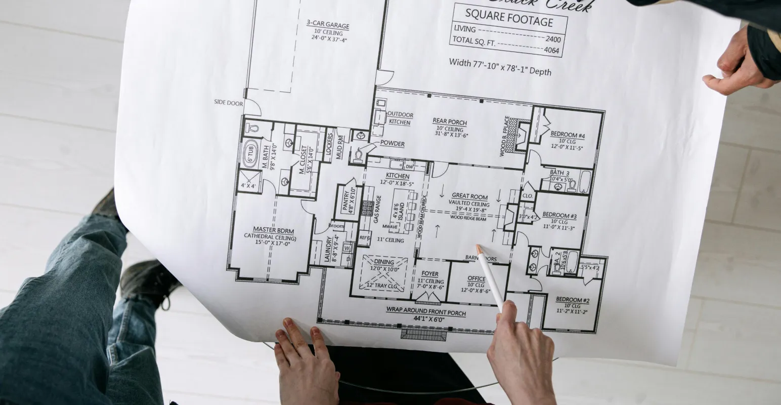 people going through architectural blueprints