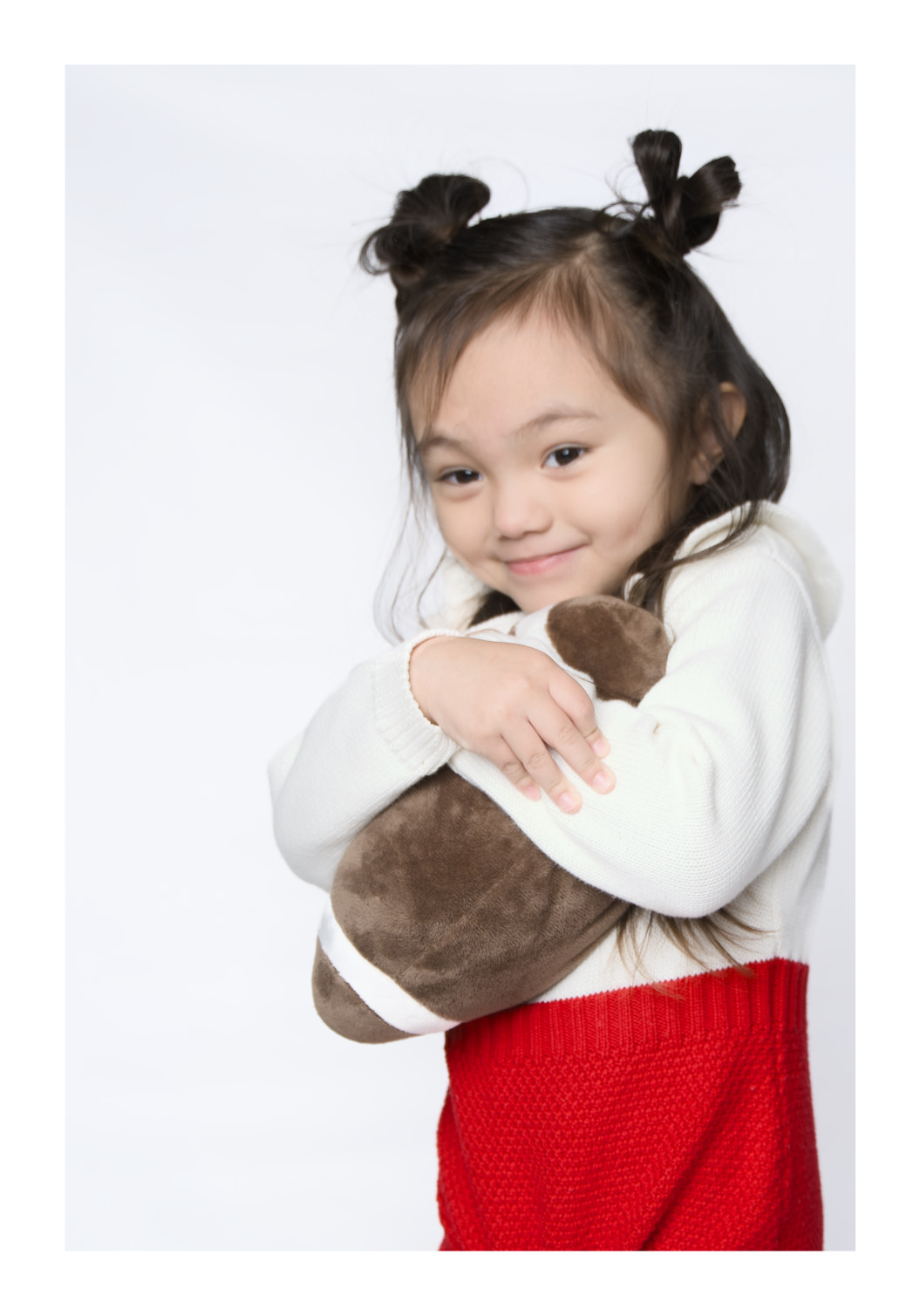 Child portrait photography — young girl smiling with stuffed animal by Danx Design