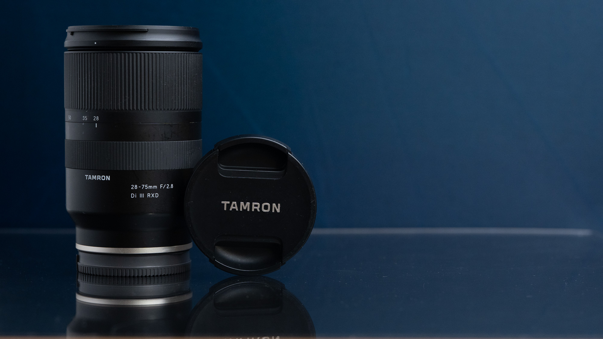 Tamron lens product photo on a deep blue studio set