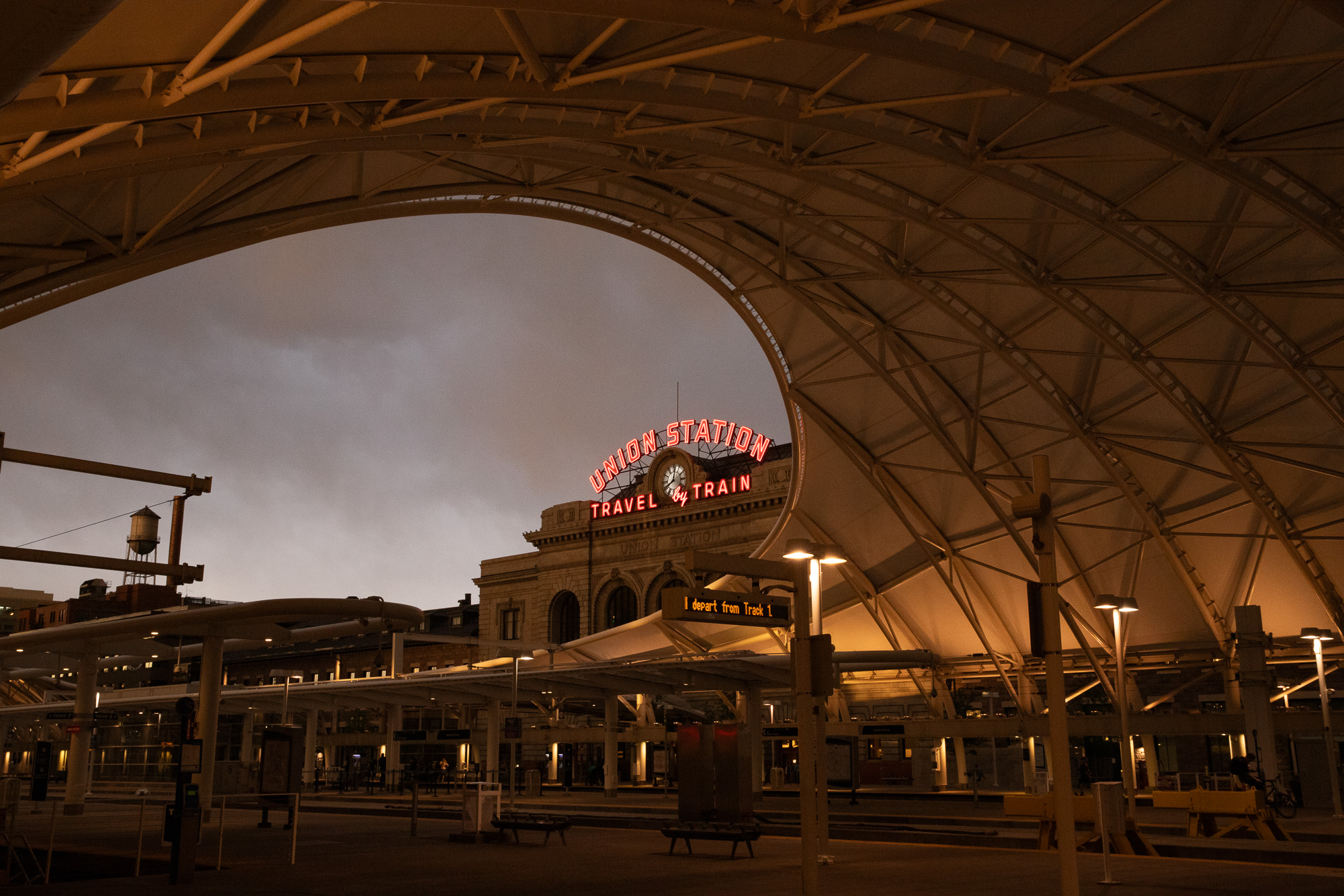 Arched canopy over a train station at dusk