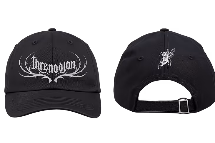Black baseball cap shown from front with white stylized 'Krenodjan' text and antler-like design, and back view with white hornet embroidery and adjustable strap.