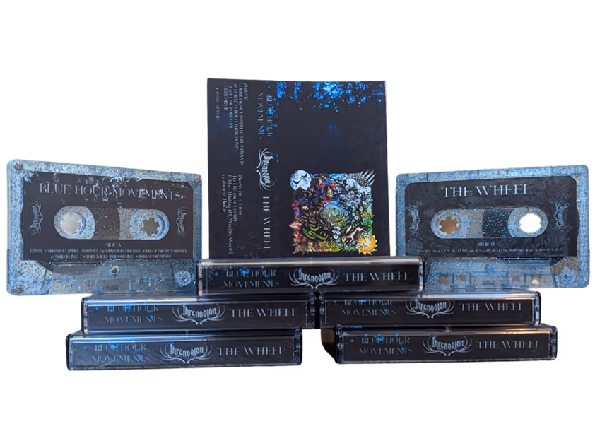 Collection of cassette tapes and cases with the titles 'Blue Hour Movements' and 'The Wheel' featuring dark-themed designs and intricate artwork.