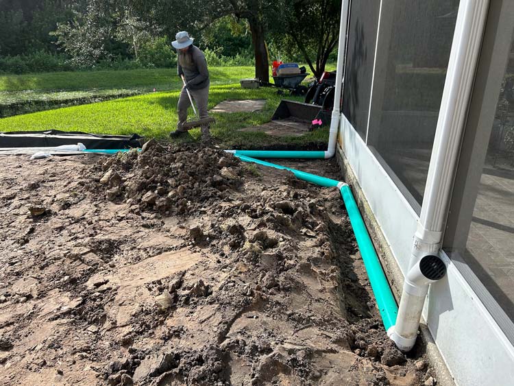 tampa bay drainage system installation with underground piping and downspout connection