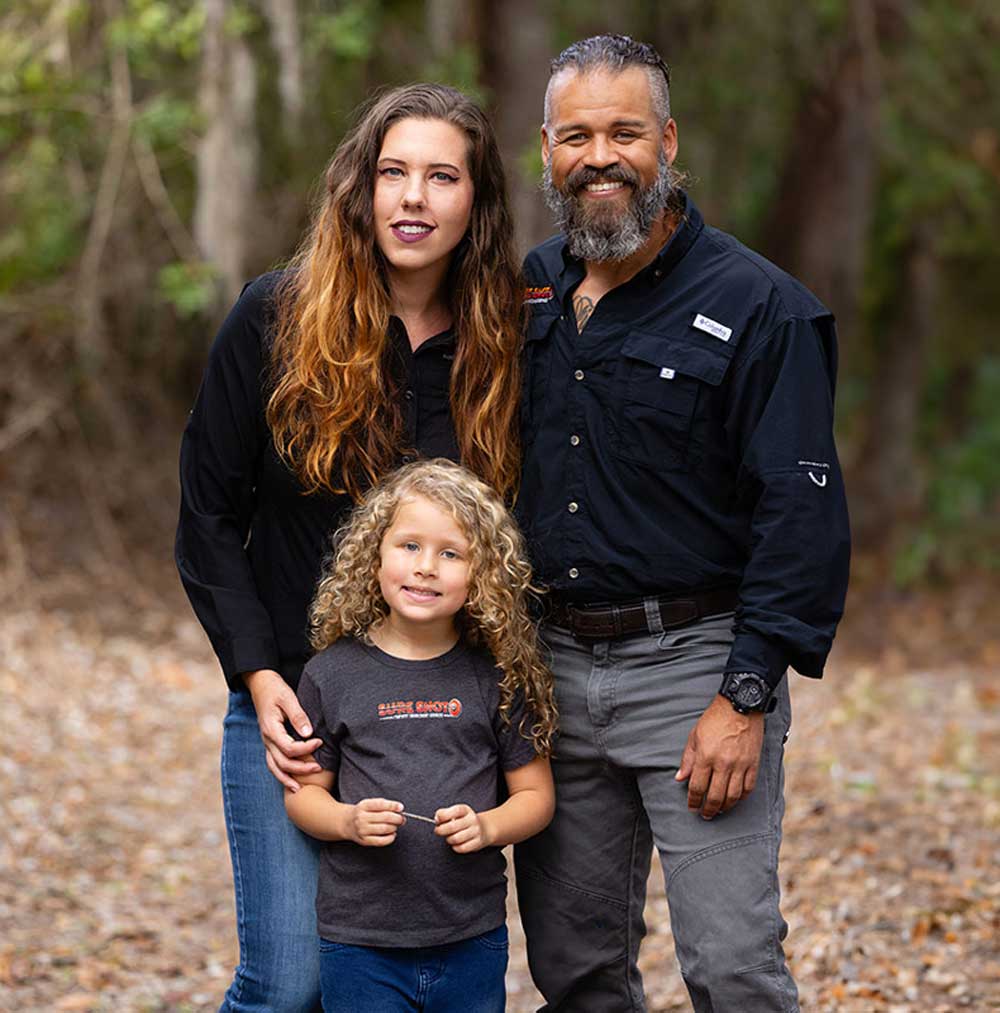 Christopher and Katrina of Sure Shot Property Enhancement Services with their daughter outdoors in Tampa Bay.