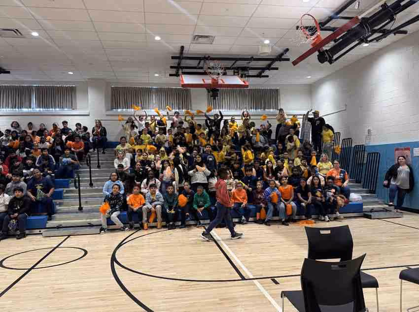 Students gathered in school gymnasium for a pep rally assembly