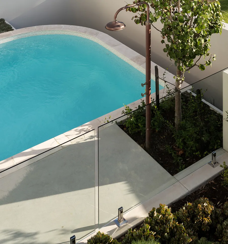 An aerial view of a swimming pool with trees.