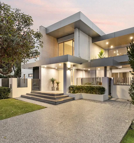 A modern house with a large front yard.