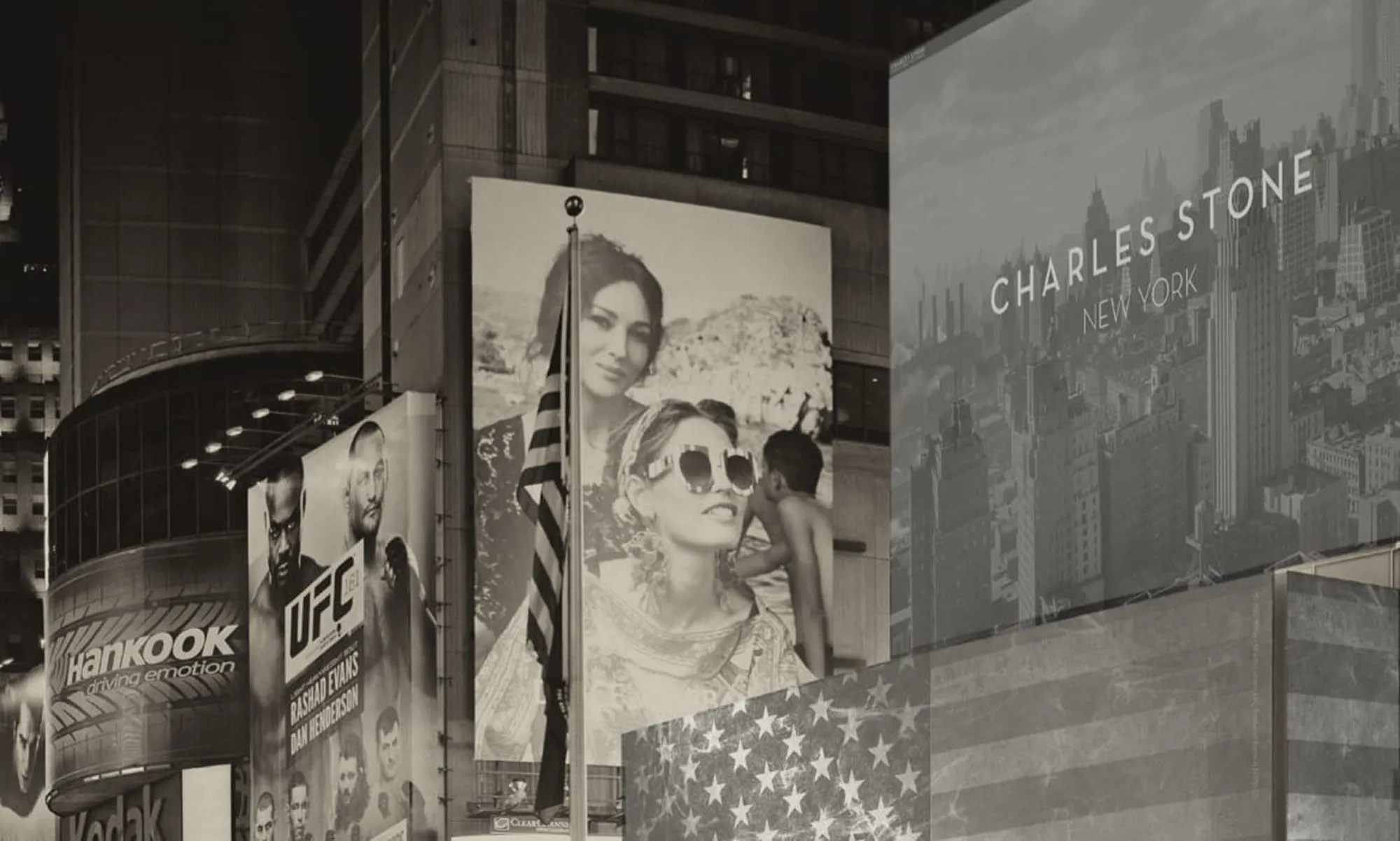 Sepia-toned Times Square billboards at night with an American flag in the foreground