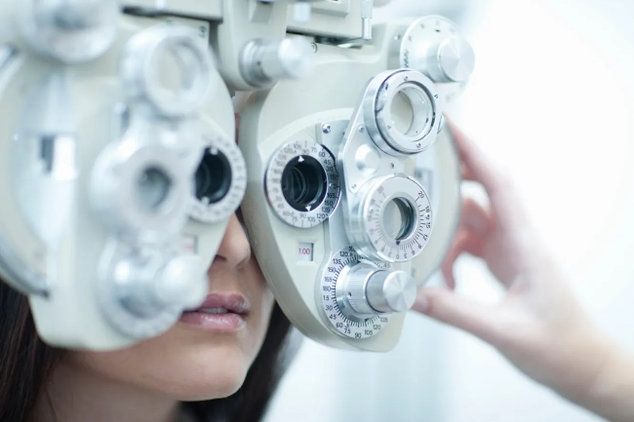 Patient having an eye test using a phoropter during a sight examination