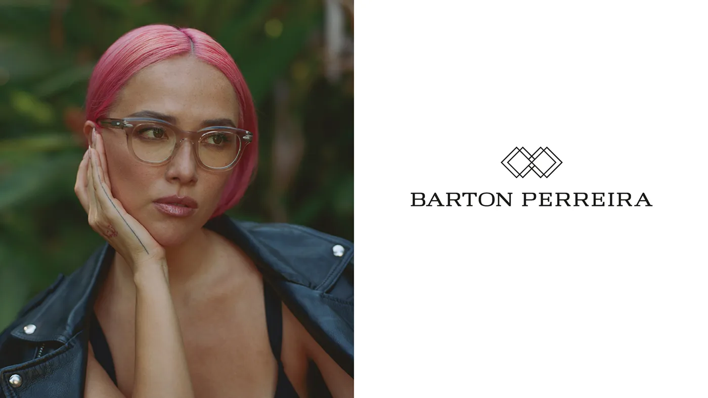 Woman with pink hair wearing clear-framed Barton Perreira eyeglasses beside the brand logo