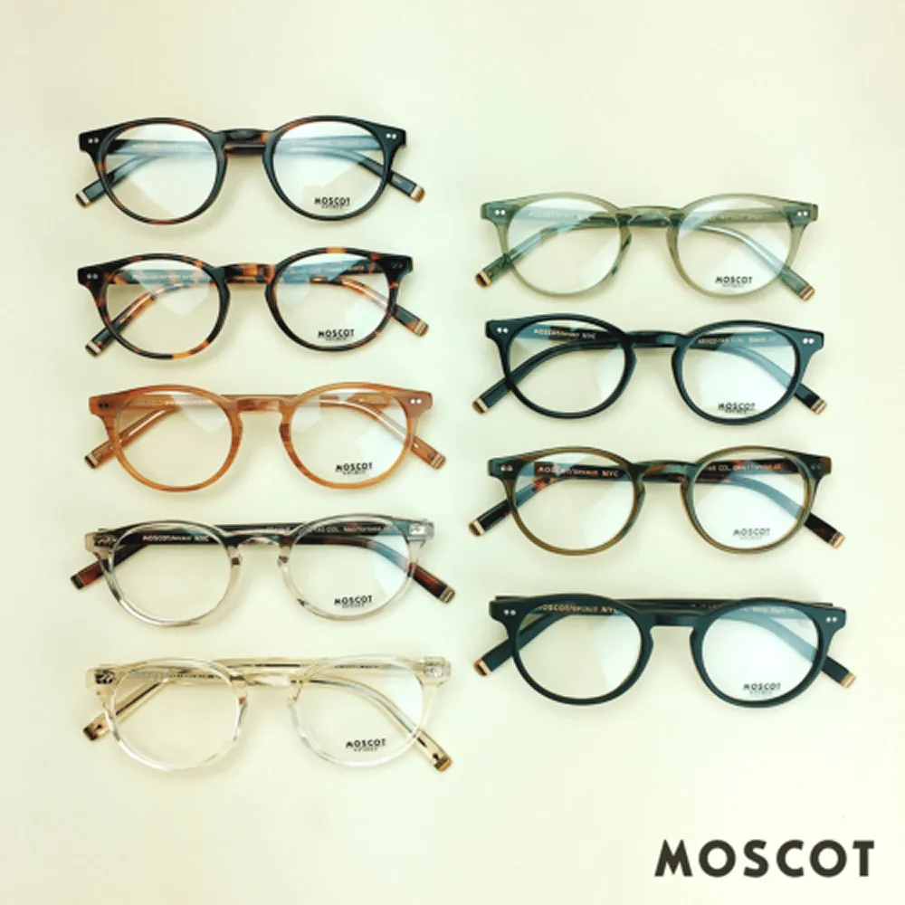 Nine pairs of round Moscot eyeglasses in various colors arranged in two columns on a white surface.