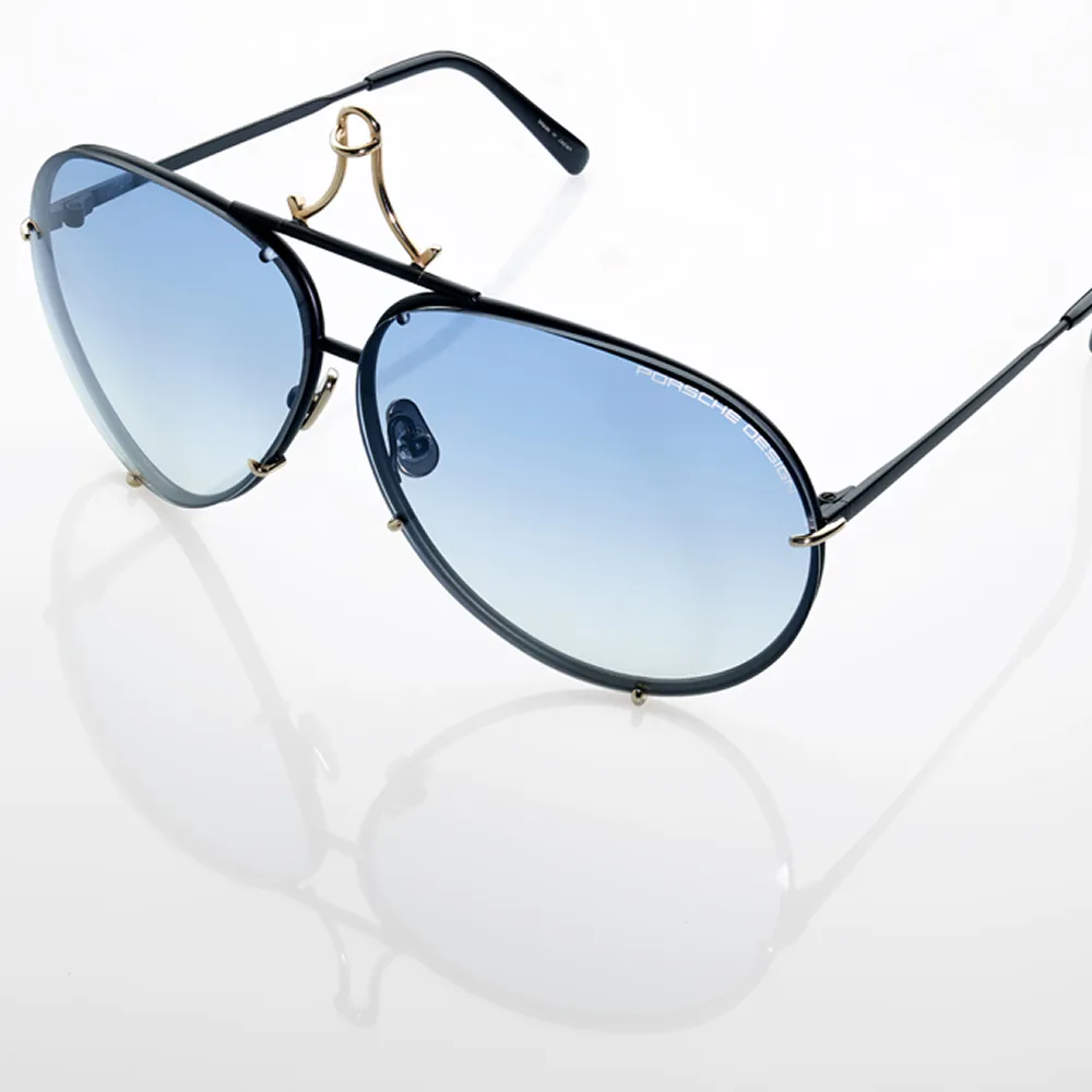Black-framed aviator sunglasses with gradient blue lenses and gold accents on a white background.