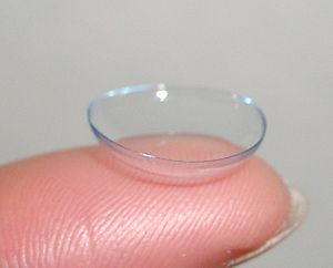 Close-up of a soft contact lens on a fingertip