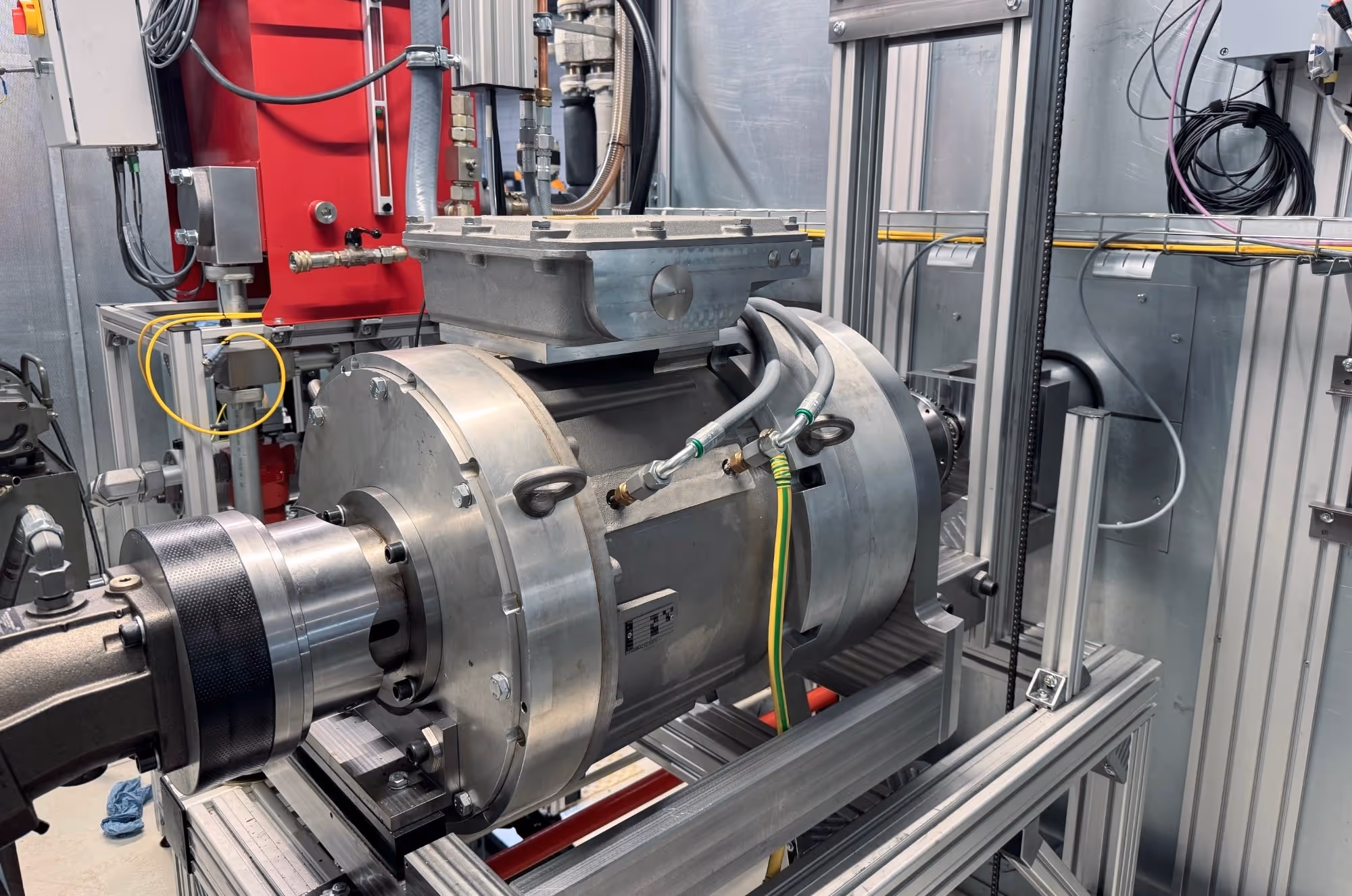 Close-up of an electro motor powering a hydraulic test setup for extensive research.