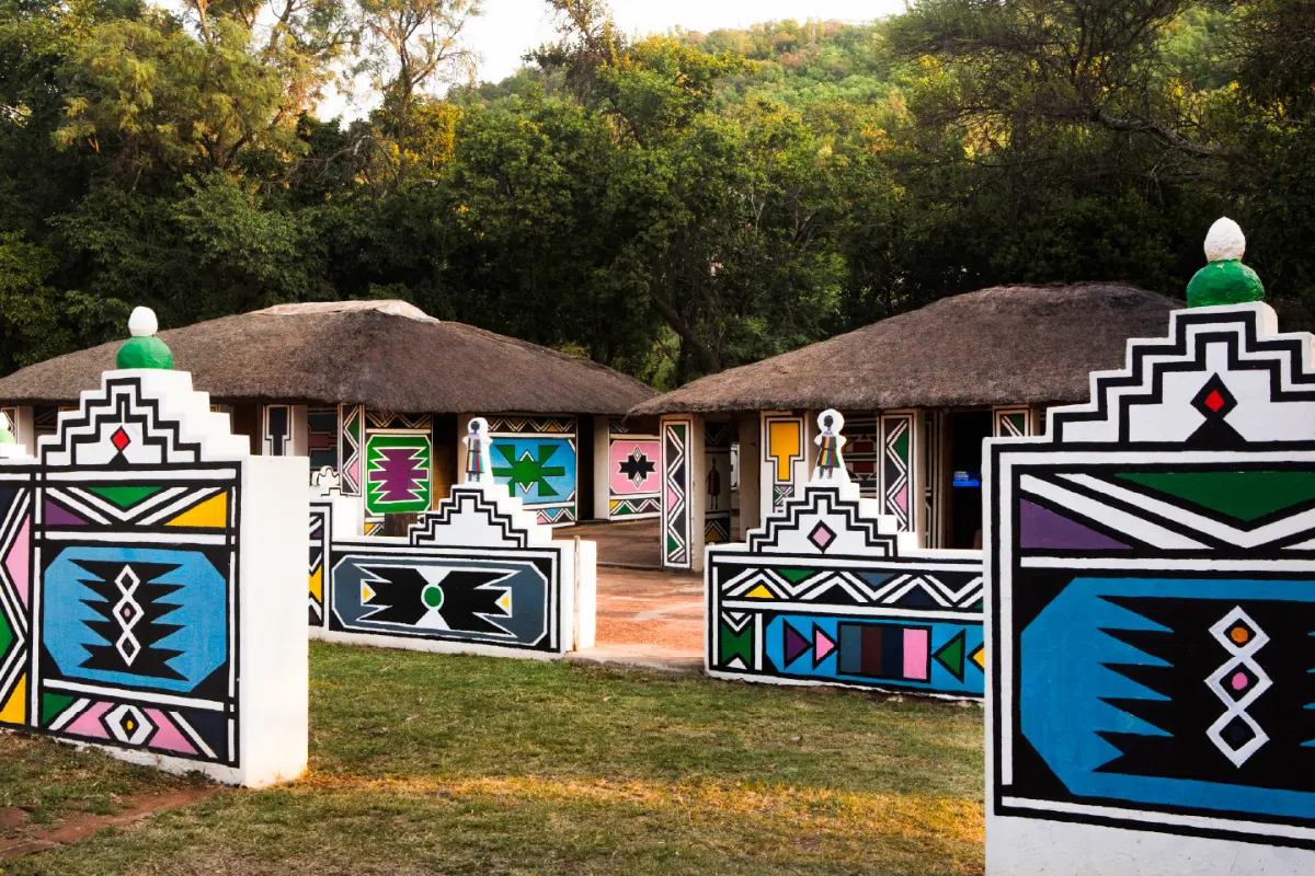 Traditional Ndebele village with colourful geometric painted walls at Zebra Nature Reserve.