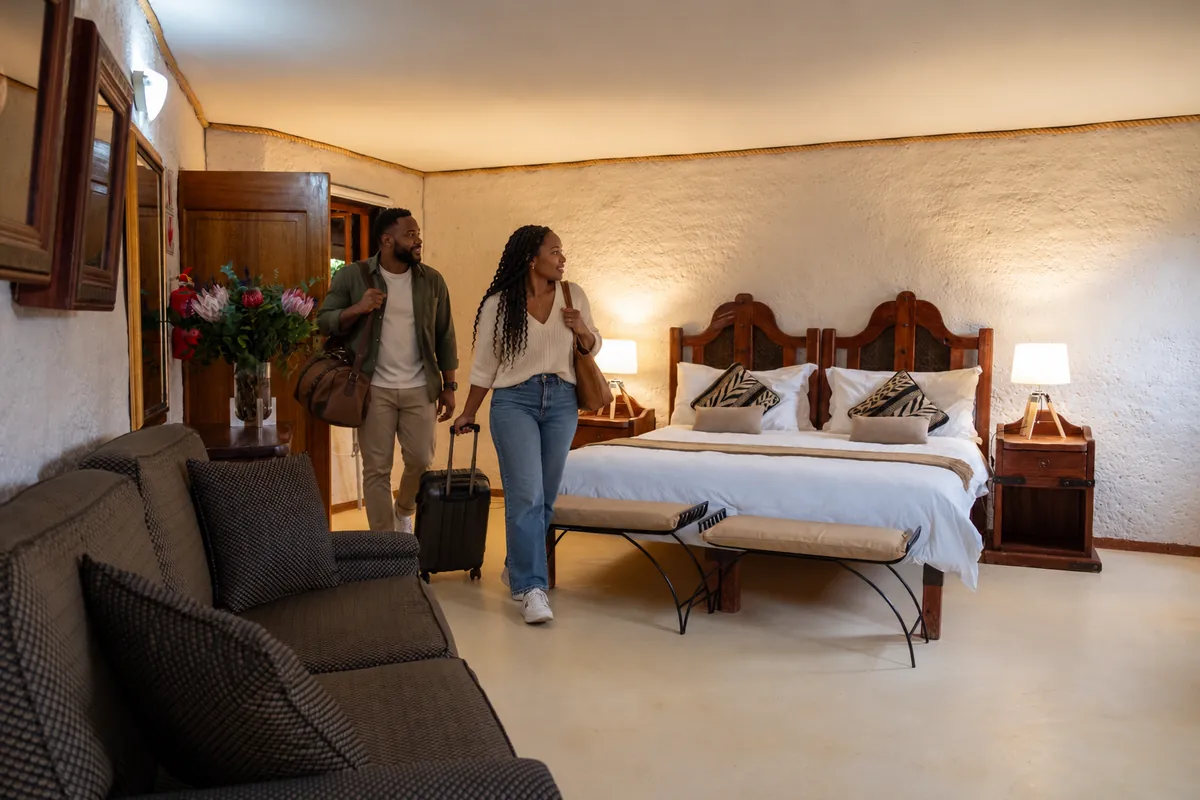 Couple arriving with luggage at their lodge room at Zebra Nature Reserve