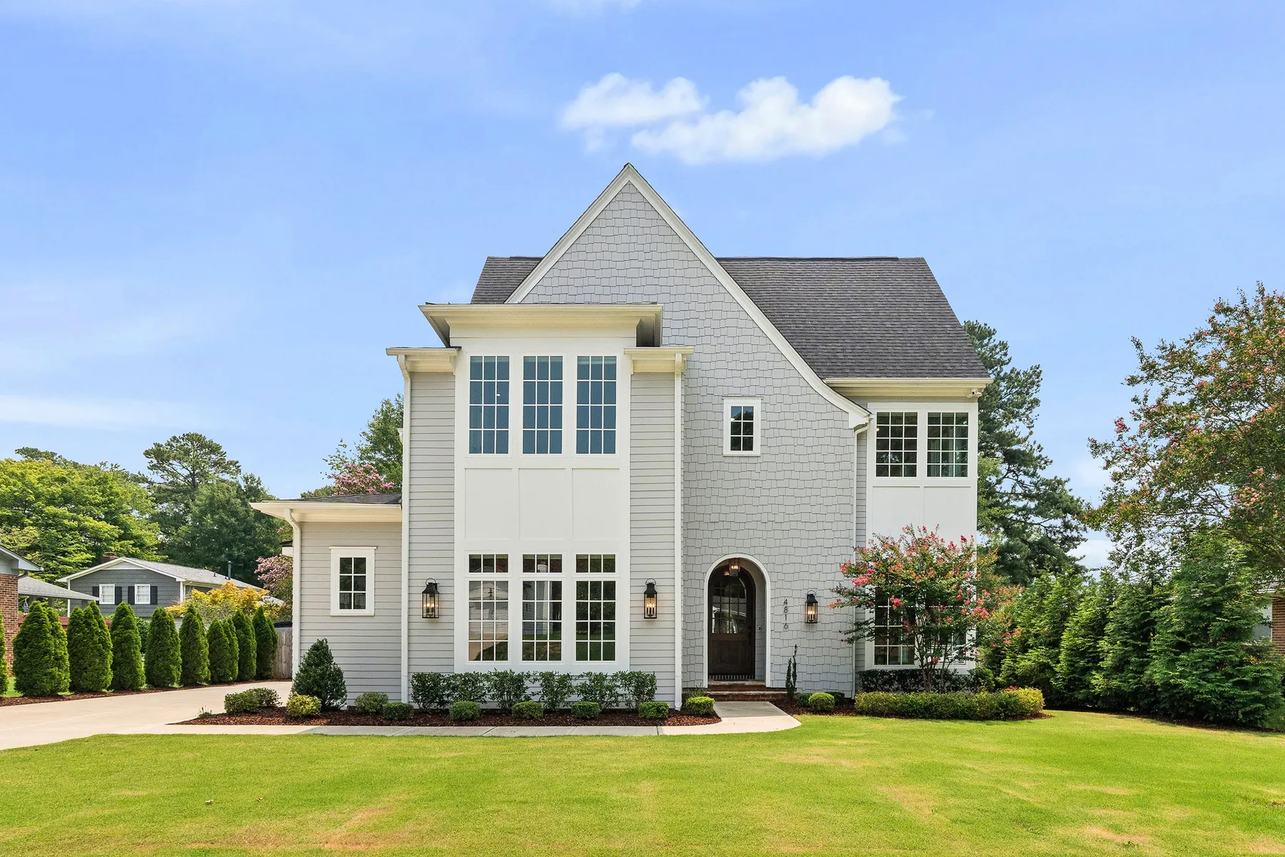 White luxury home exterior with manicured landscaping in Raleigh, North Carolina