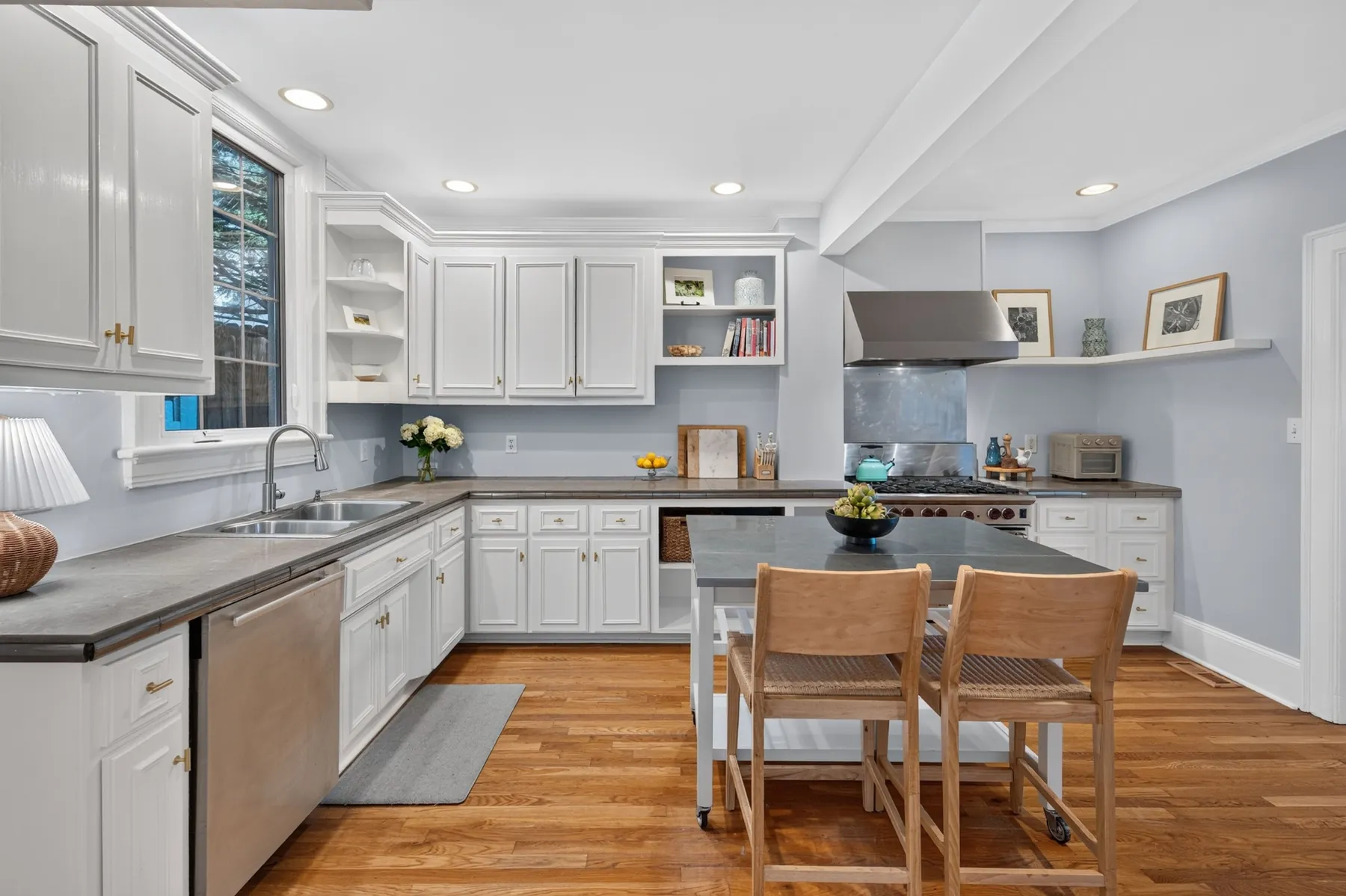 White kitchen with an island and pendant lighting in Raleigh