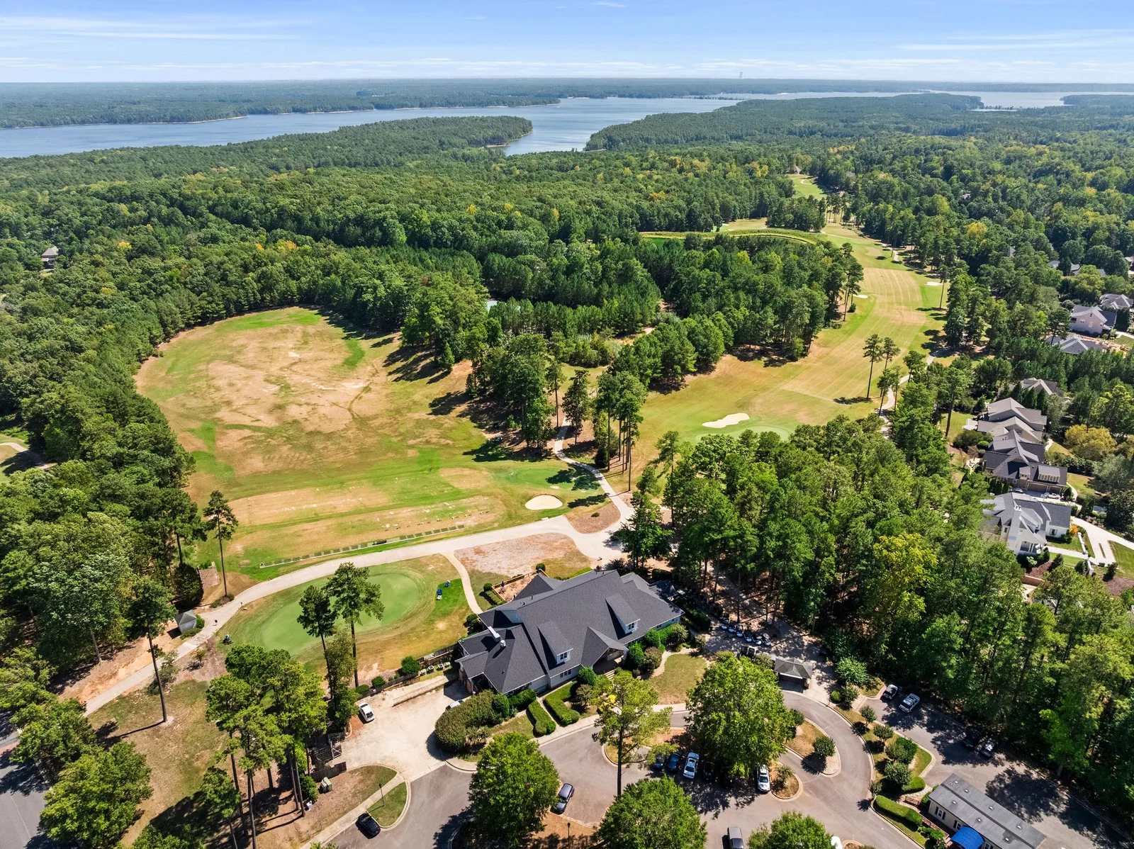 Aerial view of a wooded residential community, golf course, and lake near Chapel Hill, North Carolina.