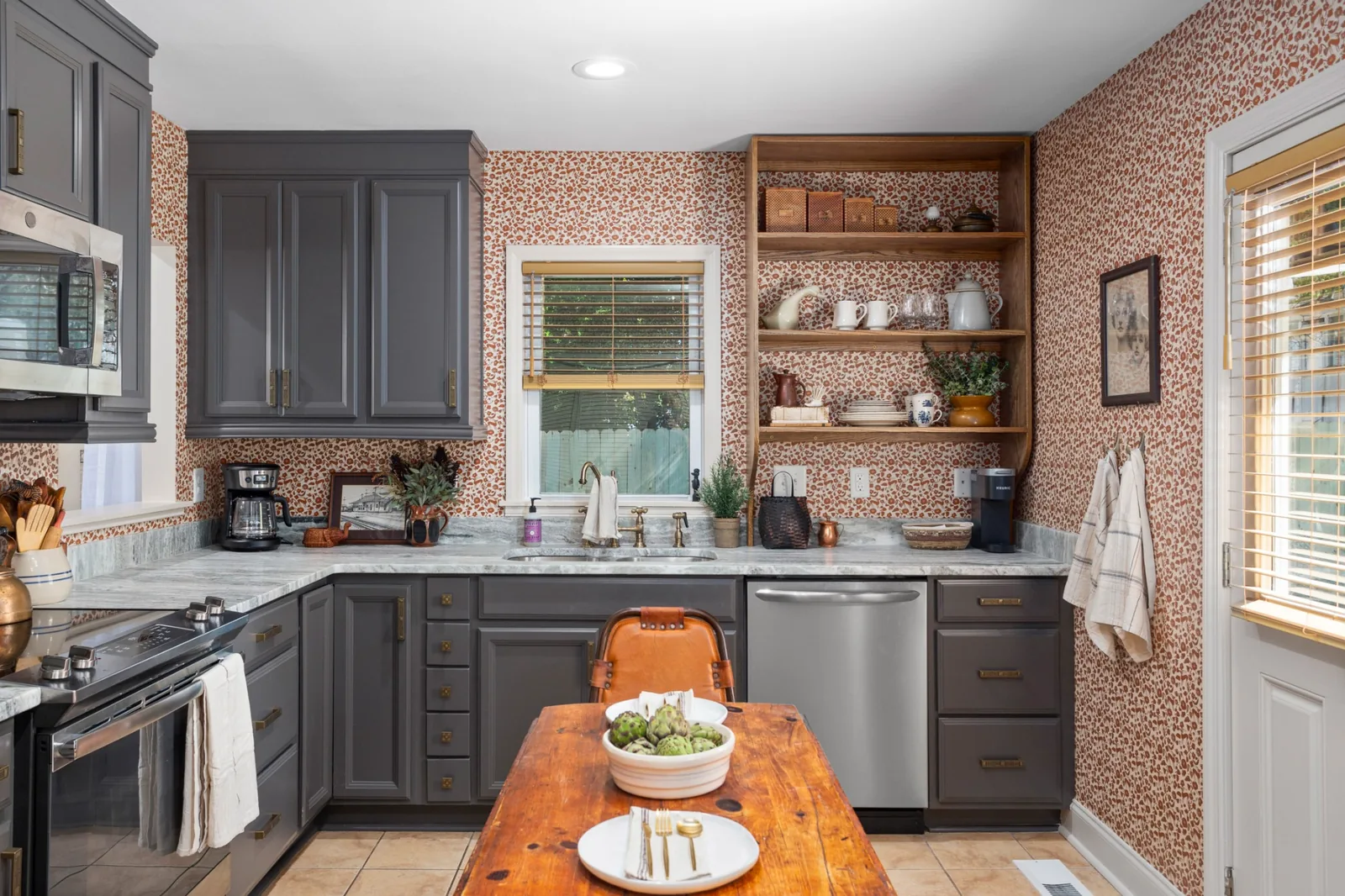Distinctive kitchen with patterned wallpaper, dark cabinetry, open shelving, and warm wood accents in Chapel Hill, North Carolina.