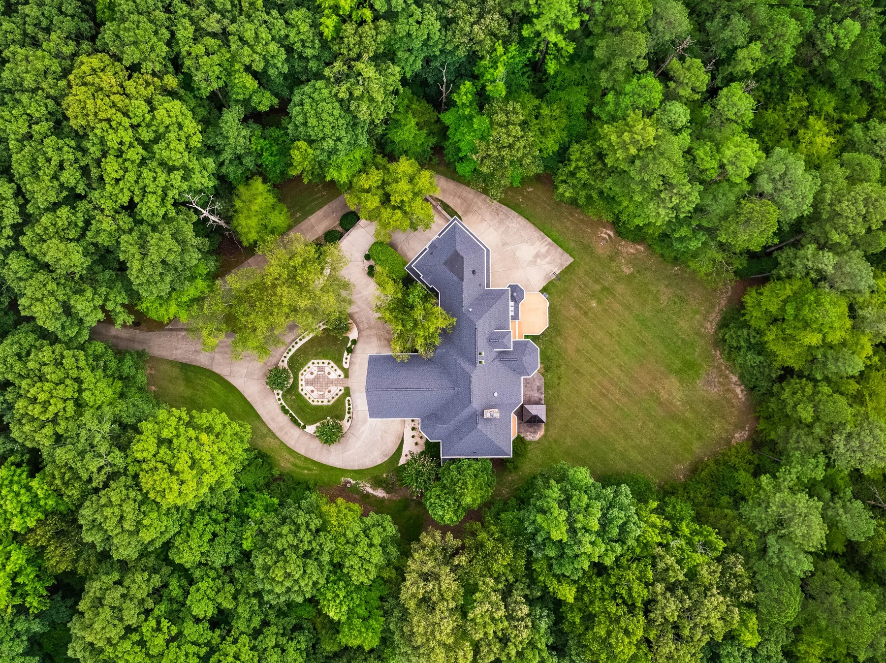 Top-down drone photo of a large Wake Forest property surrounded by trees