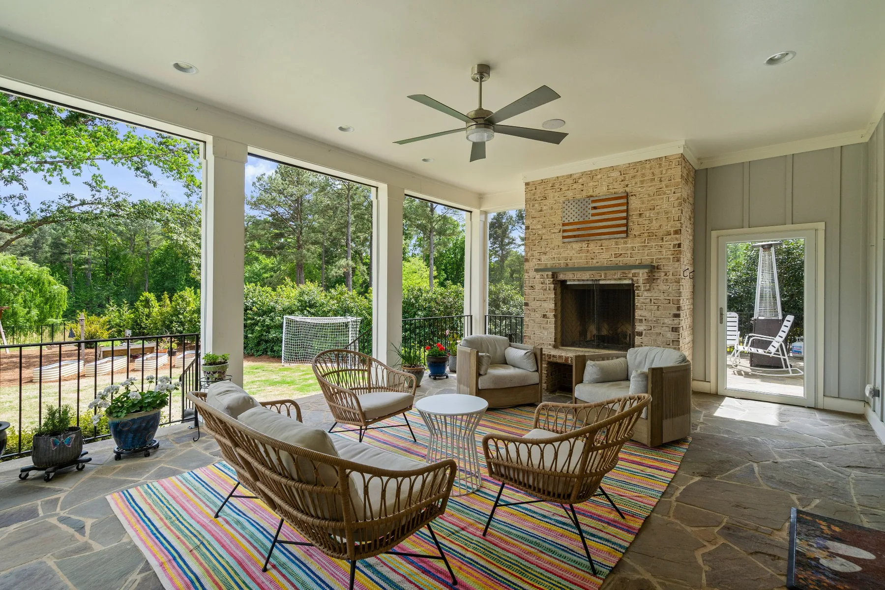 Screened porch with fireplace photographed in a Holly Springs home