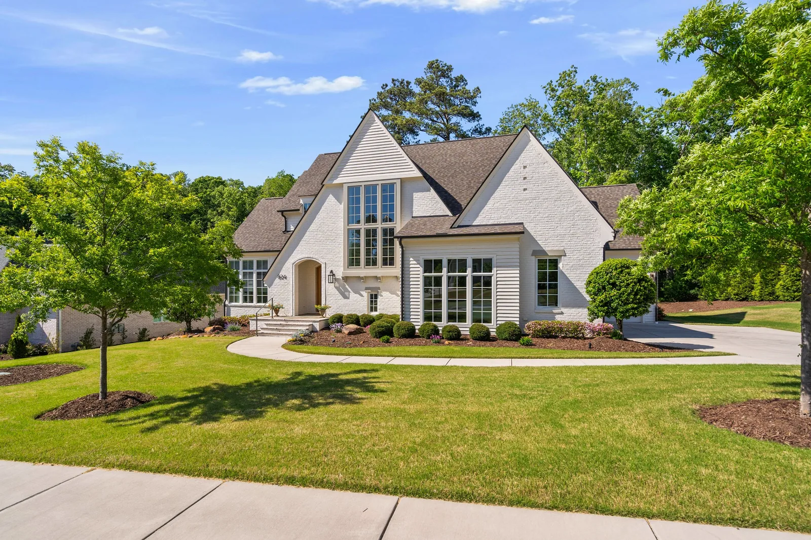 Custom white brick home photographed in Garner, North Carolina