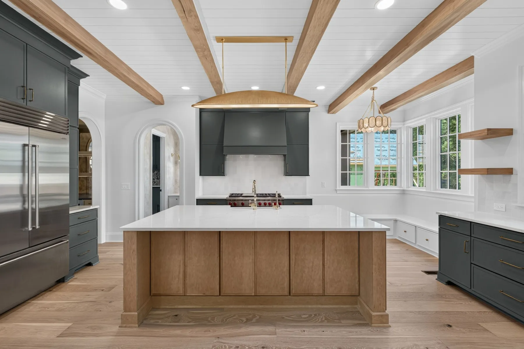 Custom kitchen with dark cabinetry and exposed wood beams in Zebulon, NC