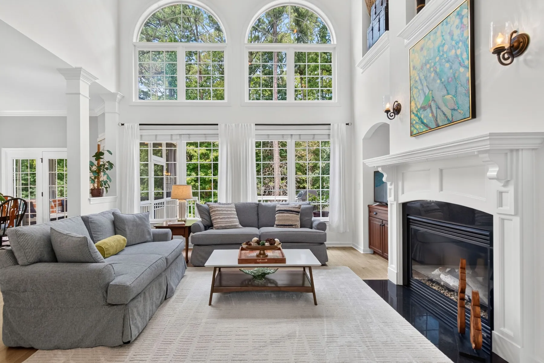 Two-story living room with arched windows and fireplace in Zebulon, NC