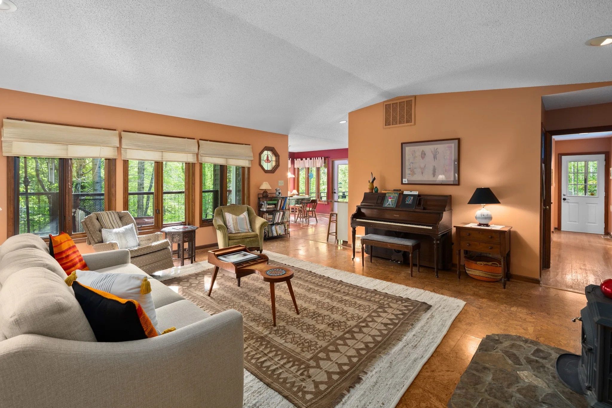 Warm rustic living space with wooded views in a Rolesville, North Carolina home.
