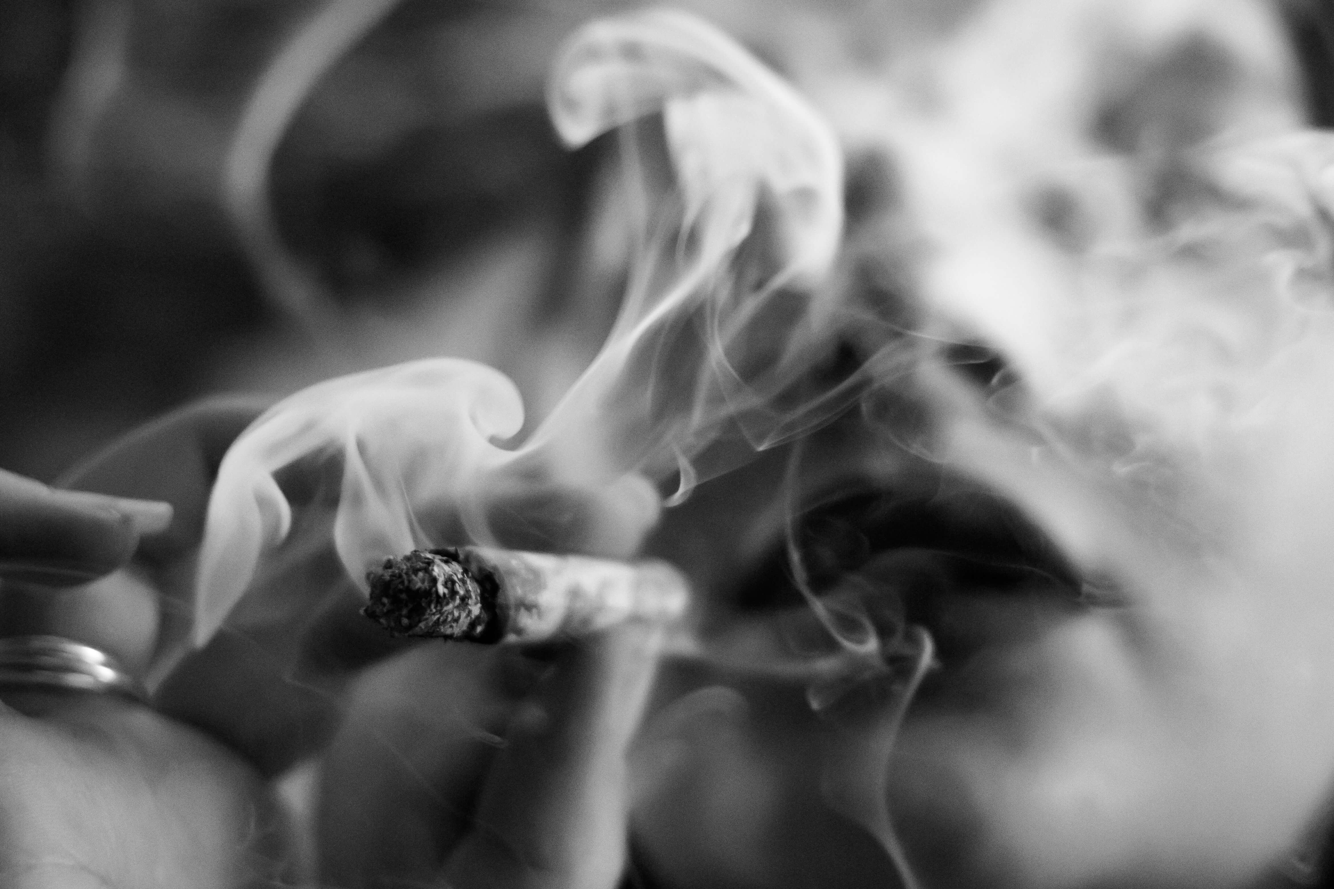 Close-up of cigarette smoke, illustrating how smoking can break down lip filler faster and affect longevity