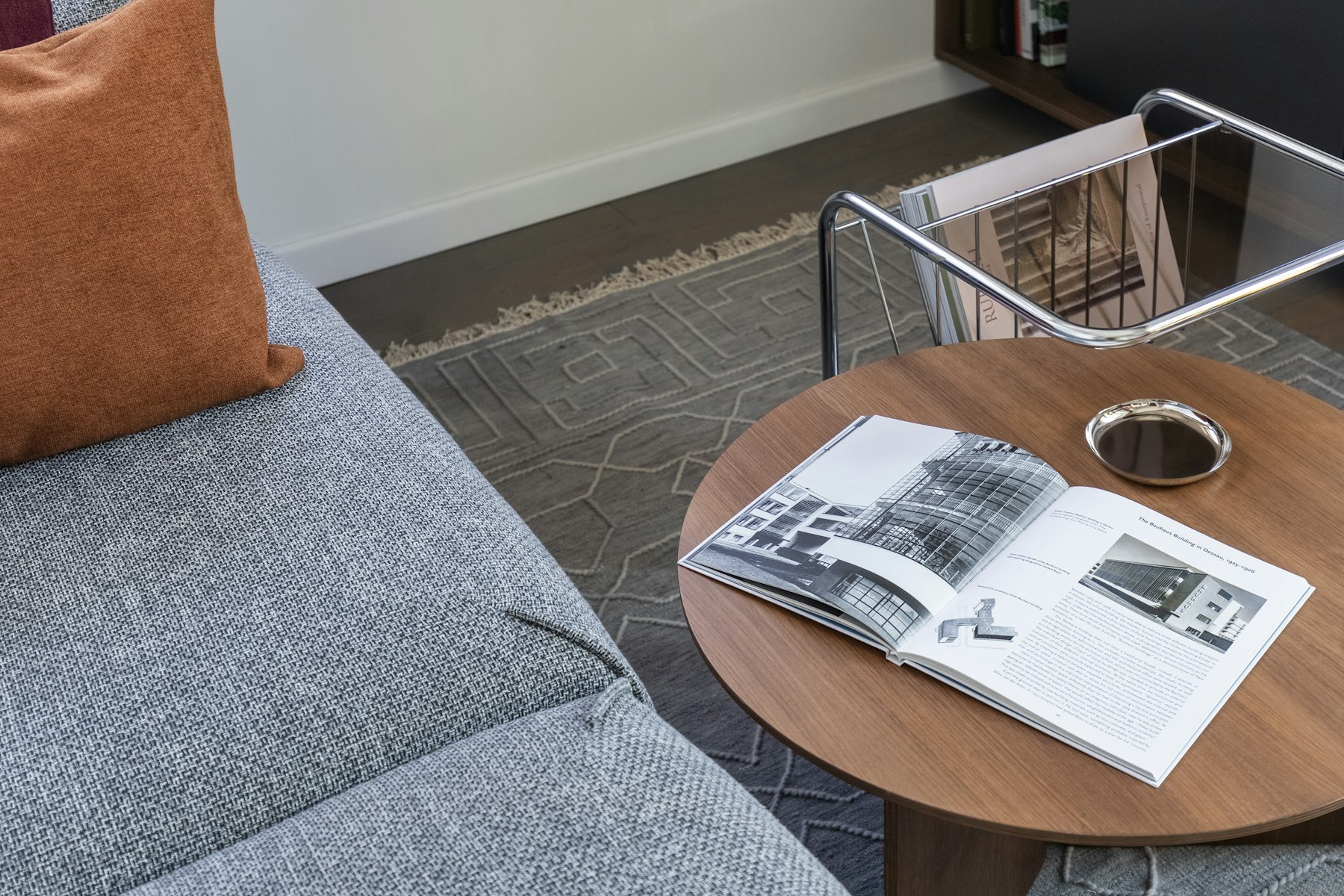 Calm mid-century lounge with a timber side table in soft daylight